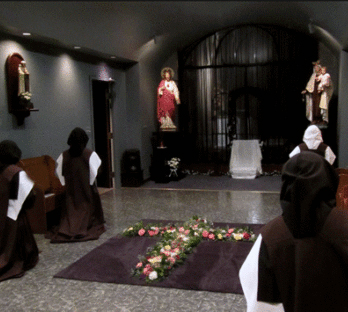 Sisters (Novice in front) prays before the profession ceremony