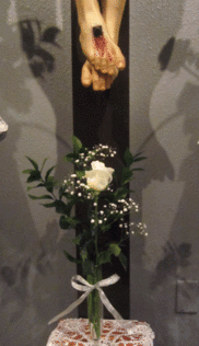 Single rose at the foot of the crucifix symbolizes the Sister who is making her profession