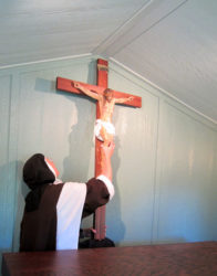 Hanging the new crucifix in the hermitage