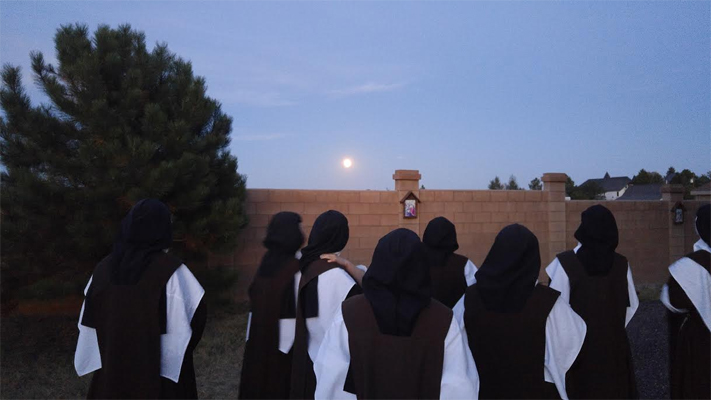 Sisters stepped out of recreation to see the lunar eclipse