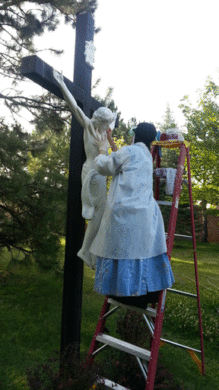 One of the Sisters repairing our outside crucifix